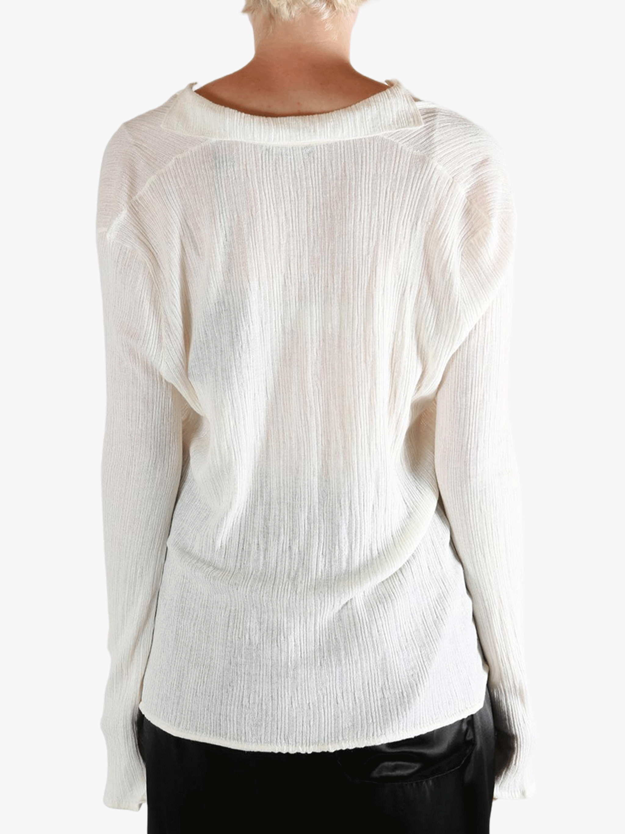 White sweater worn by a person, showing the sweater's fit
