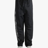 Black pants worn by a person, showing the pants's fit