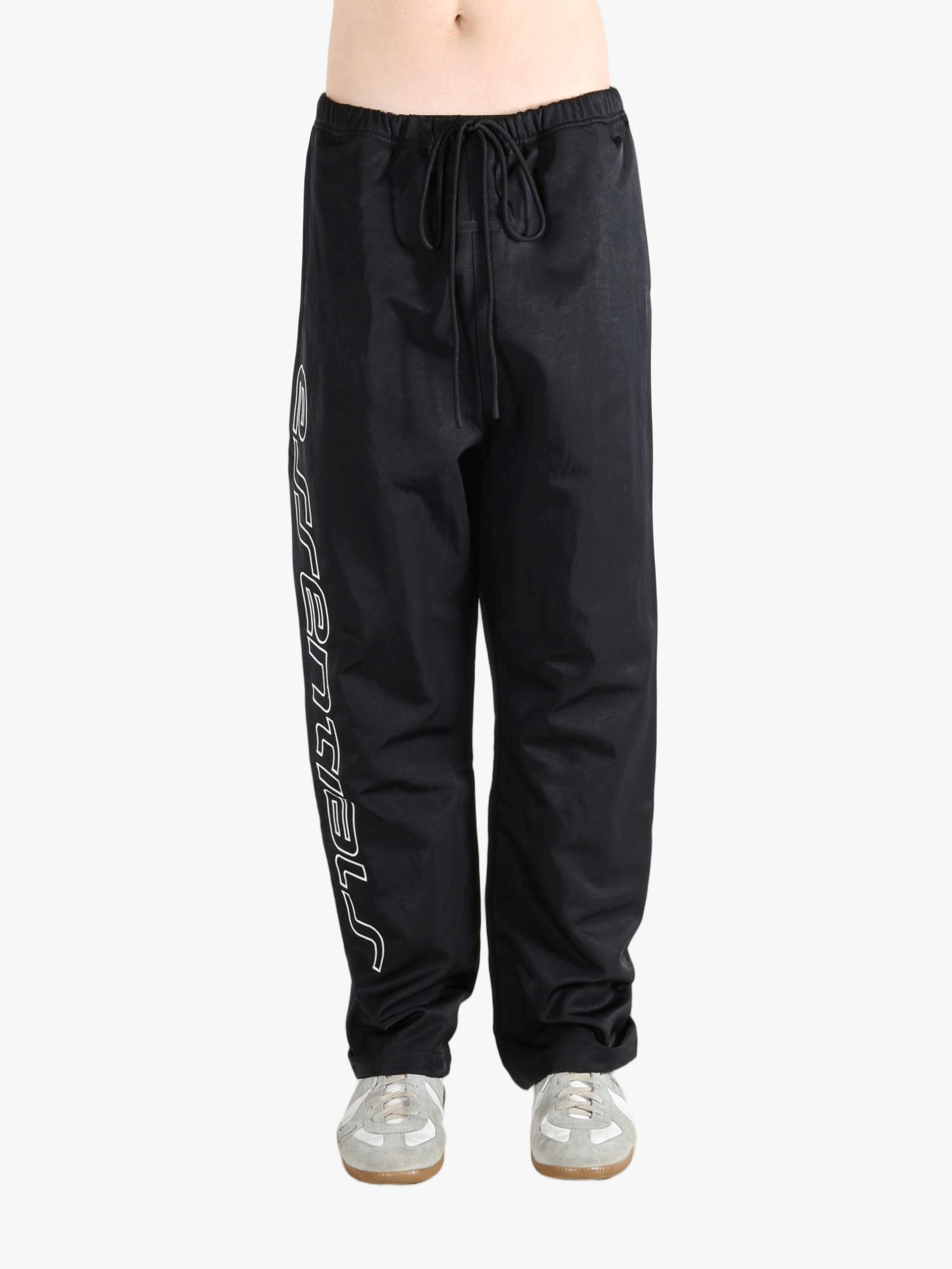 Black pants worn by a person, showing the pants's fit