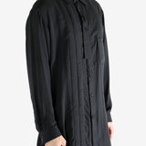 Black shirt worn by a person, showing the shirt's fit