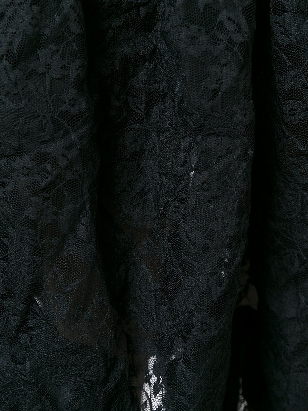 Close up of black skirt , showing texture of the polyester fabric