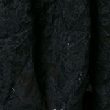 Close up of black skirt , showing texture of the polyester fabric