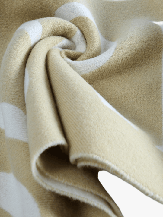Close up of tan scarve, showing texture of the wool fabric