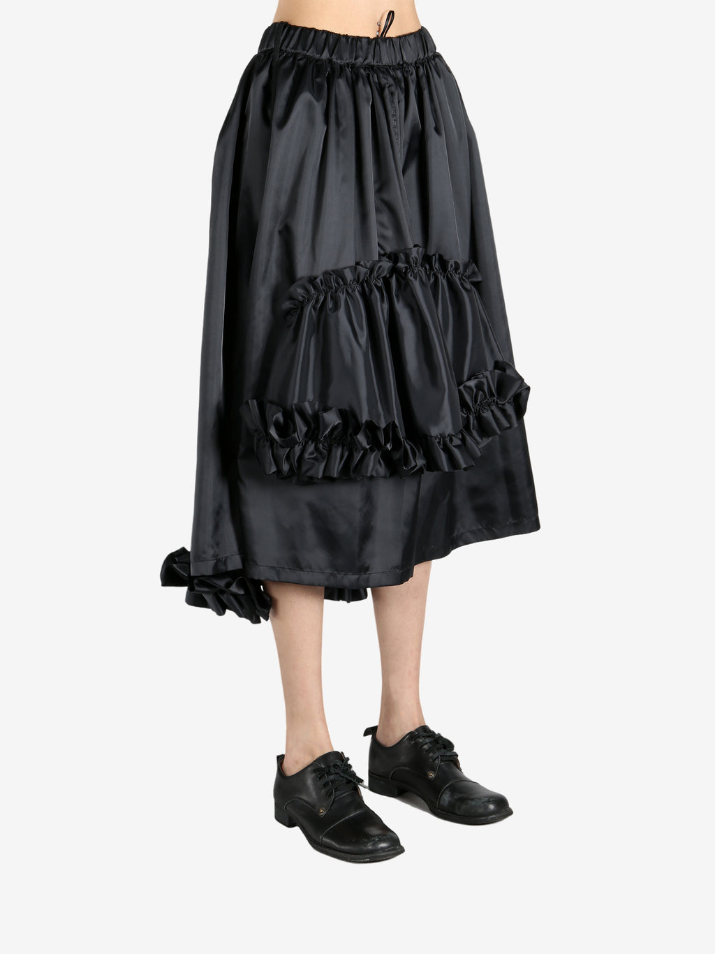 Black skirts worn by a person, showing the skirts fit