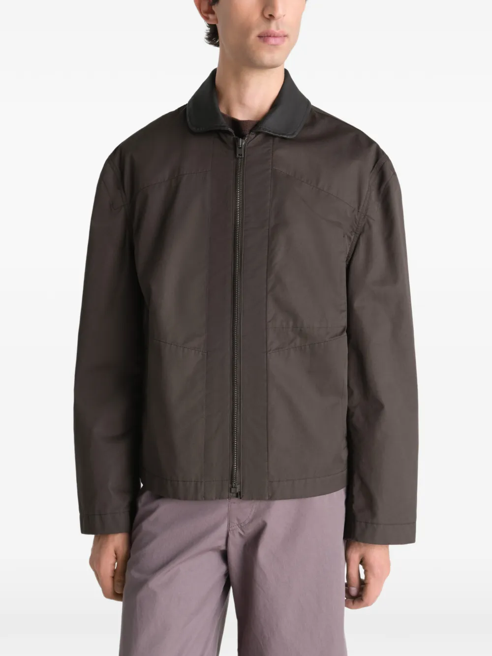 Brown jacket worn by a person, showing the jacket fit