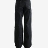 Black pants worn by a person, showing the pants' fit