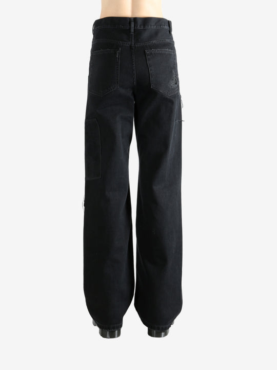 Black pants worn by a person, showing the pants' fit