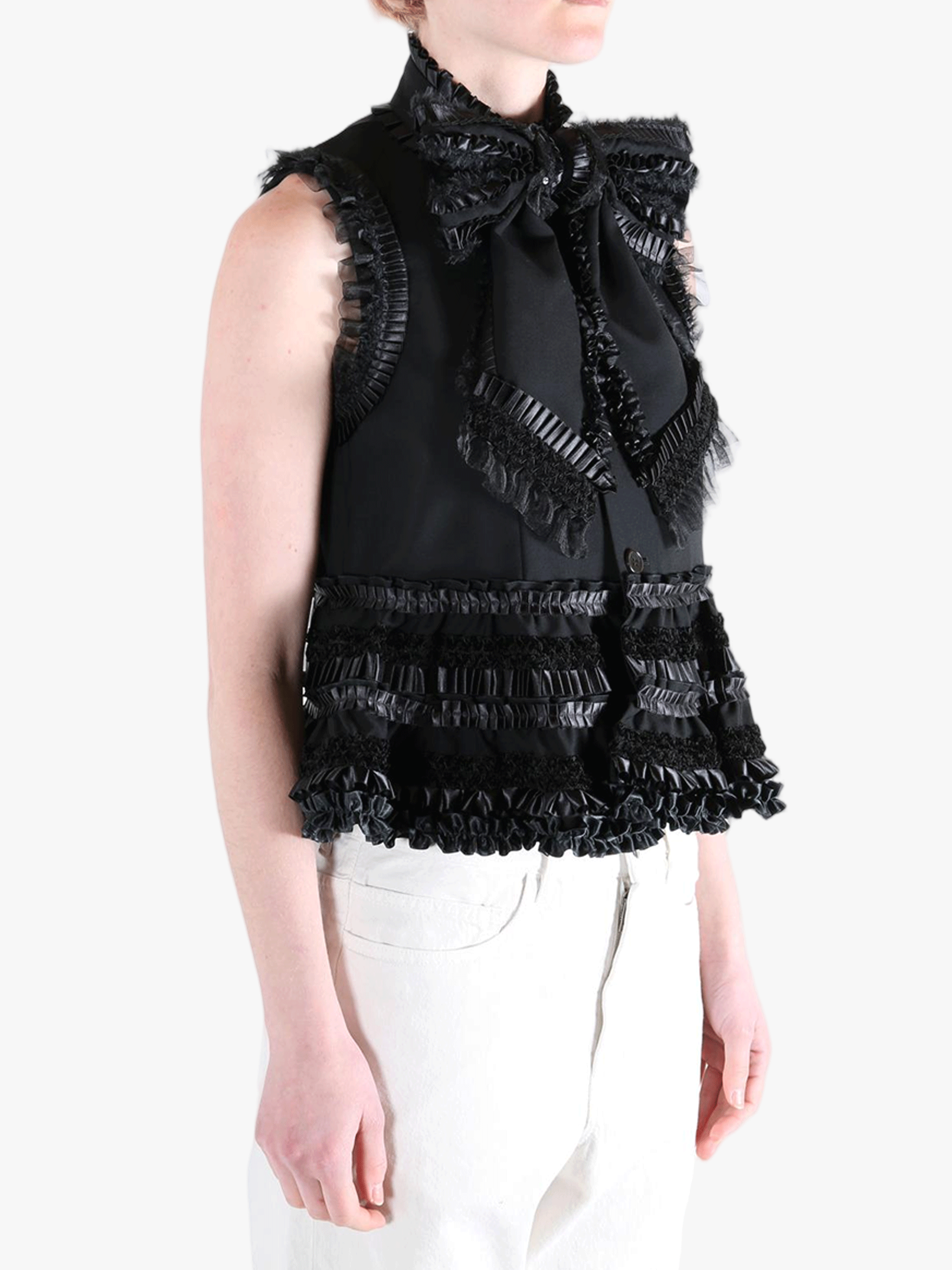 Black tops worn by a person, showing the tops fit