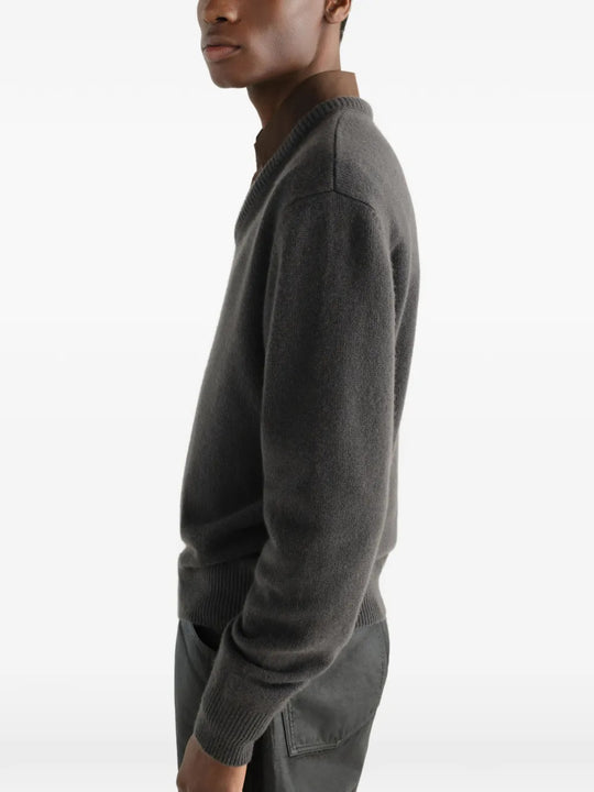 Grey knitwear worn by a person, showing the knitwear fit