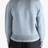 Blue pullover worn by a person, showing the pullover's fit