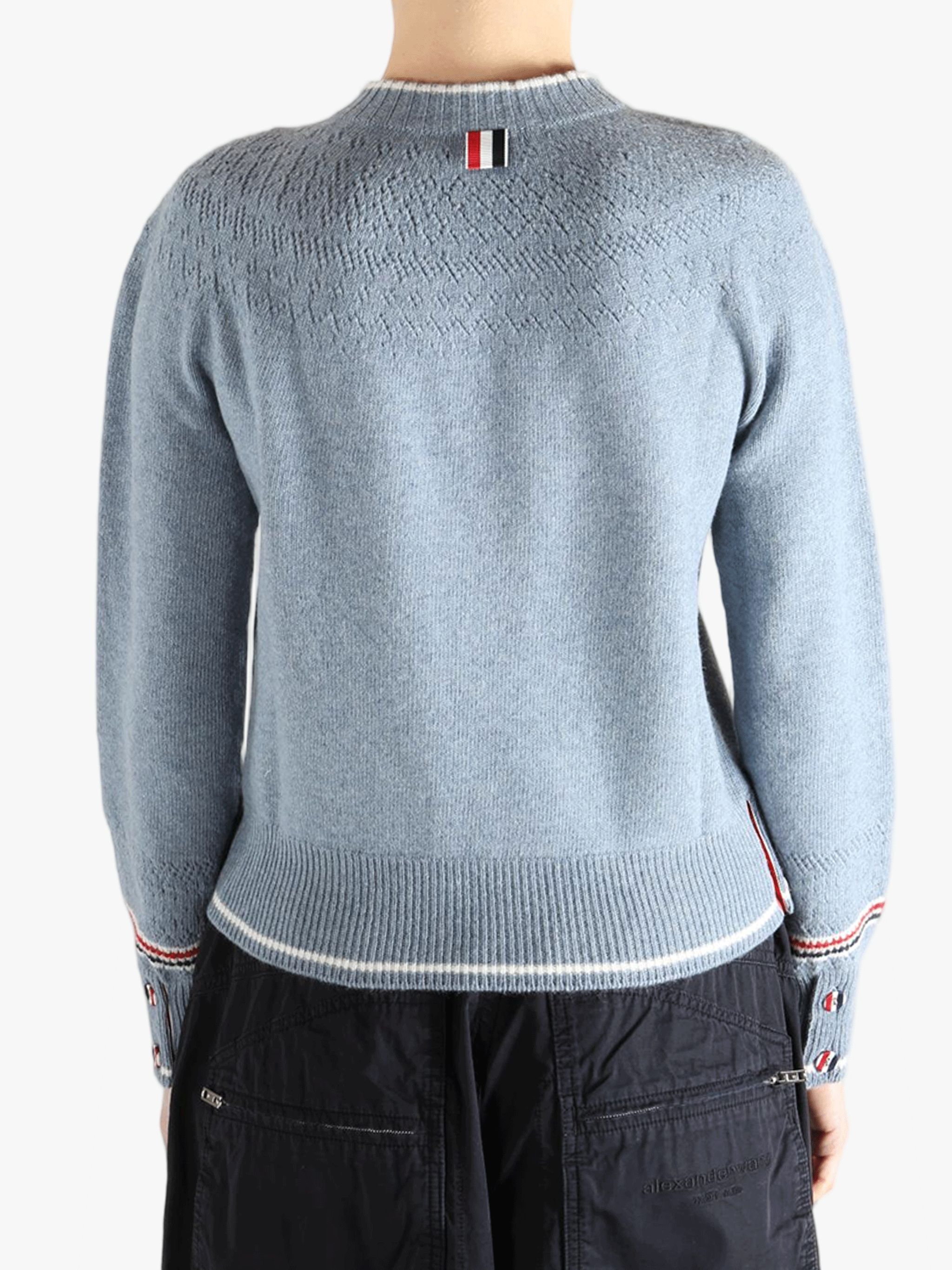 Blue pullover worn by a person, showing the pullover's fit