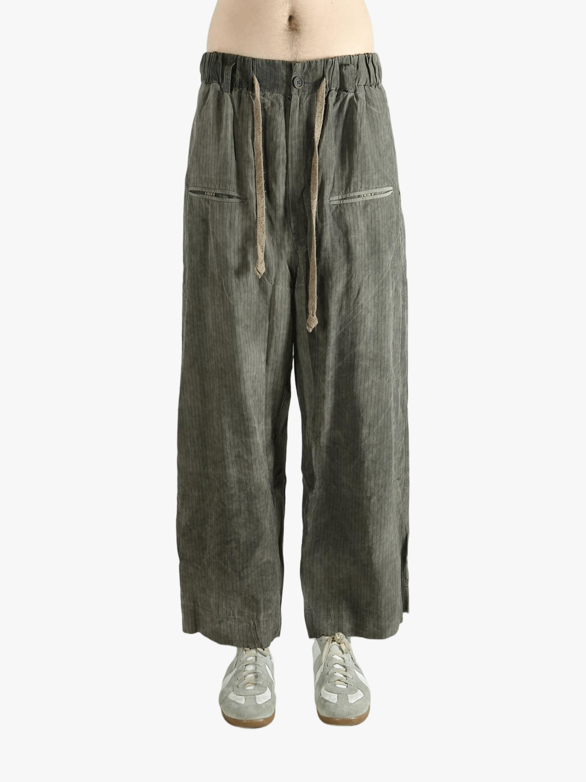 Green wide-leg pants worn by a person, showing the pants fit