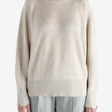 Grey knitwear worn by a person, showing the knitwear fit