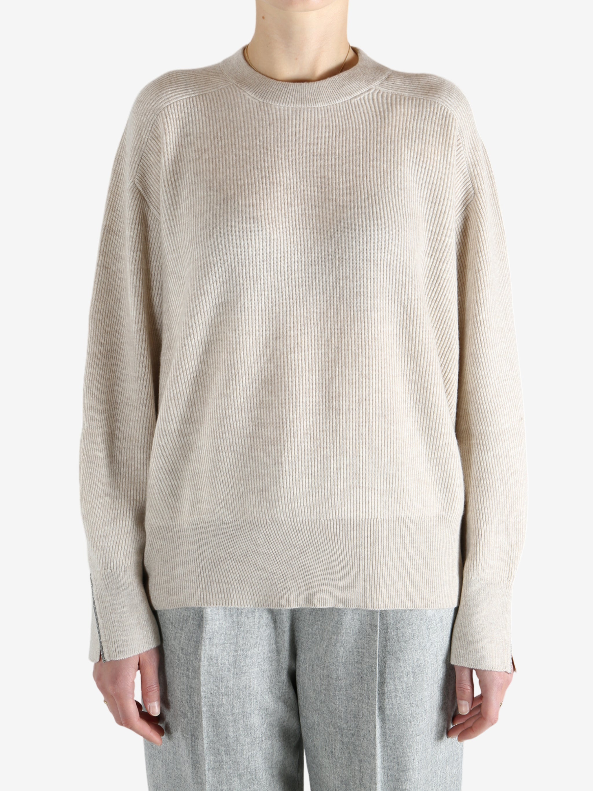 Grey knitwear worn by a person, showing the knitwear fit