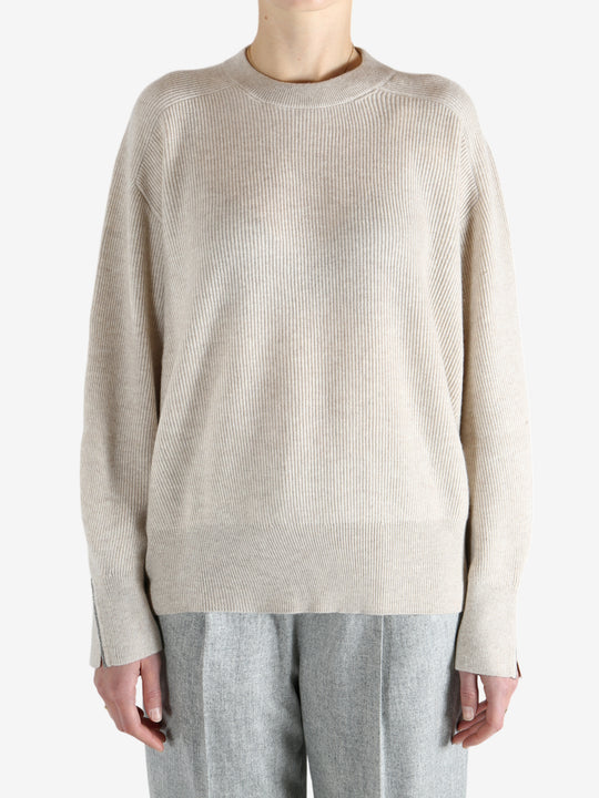 Grey knitwear worn by a person, showing the knitwear fit