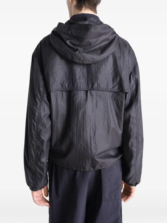 Black jacket worn by a person, showing the jacket fit