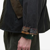 Green jacket worn by a person, showing the jacket fit