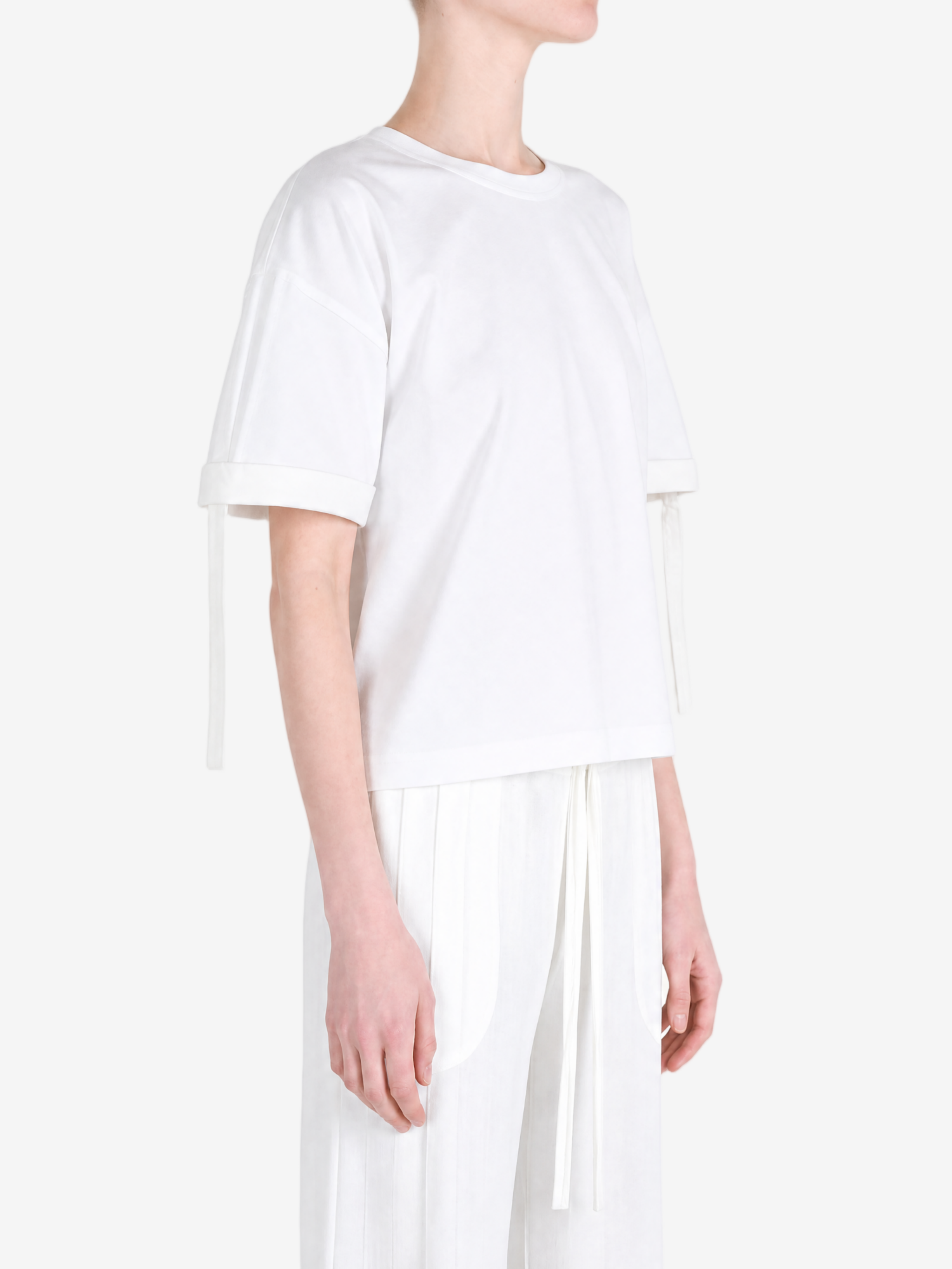 White t-shirt worn by a person, showing the t-shirt fit