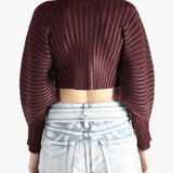 Brown cardigan worn by a person, showing the cardigan's fit