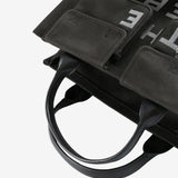 Close up of black bag,, showing texture of the cotton fabric