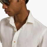 White shirt worn by a person, showing the shirt fit