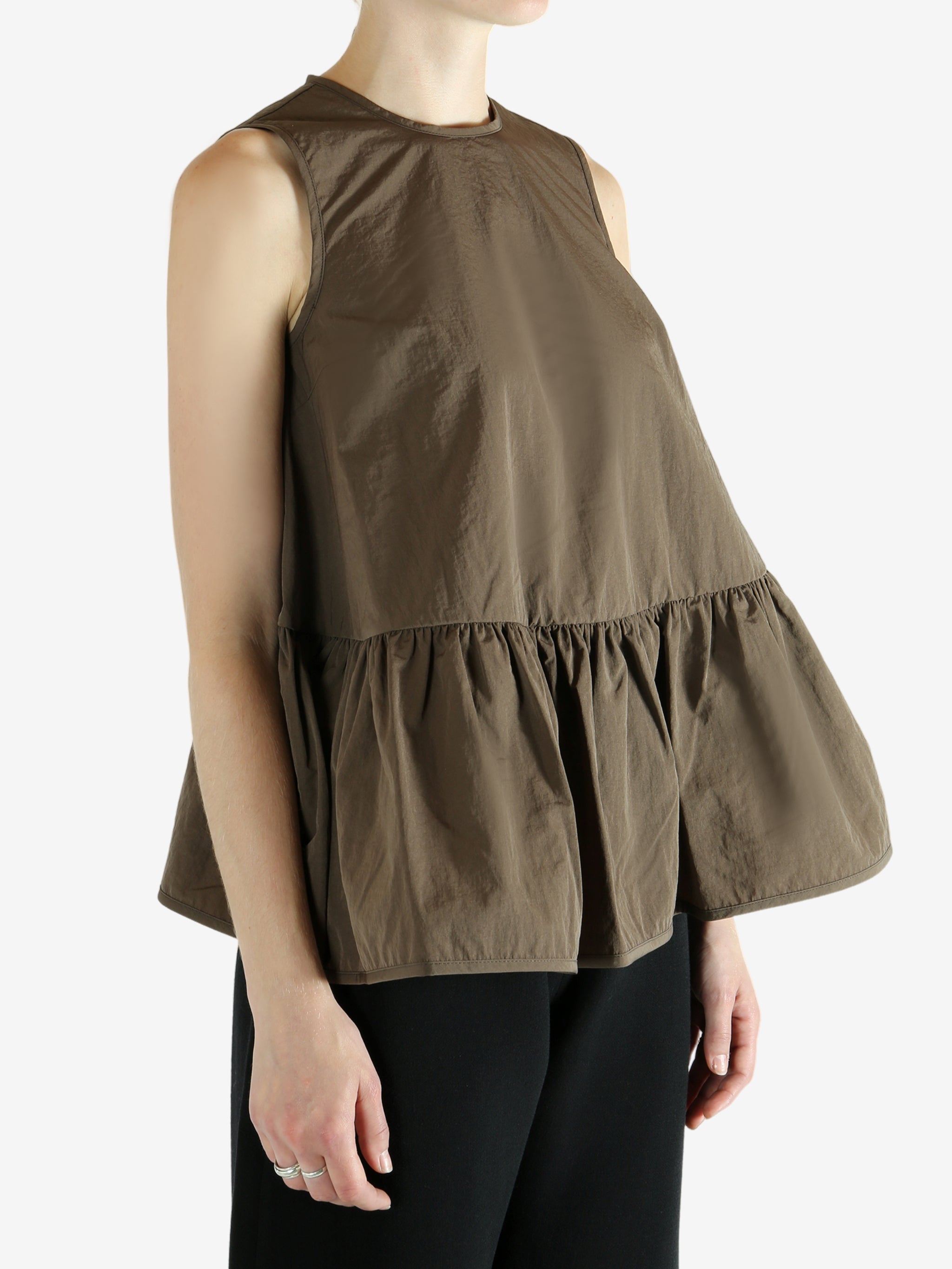 Brown top worn by a person, showing the top's fit