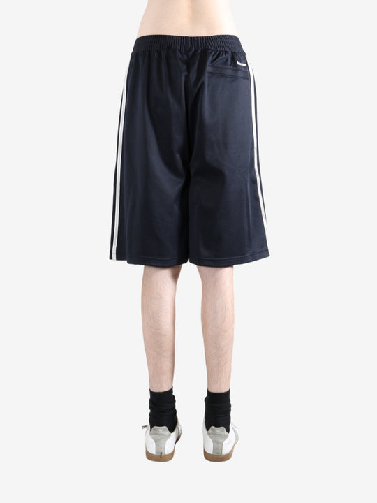 Navy shorts worn by a person, showing the shorts fit