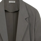Close up of grey blazer, showing texture of the cotton fabric
