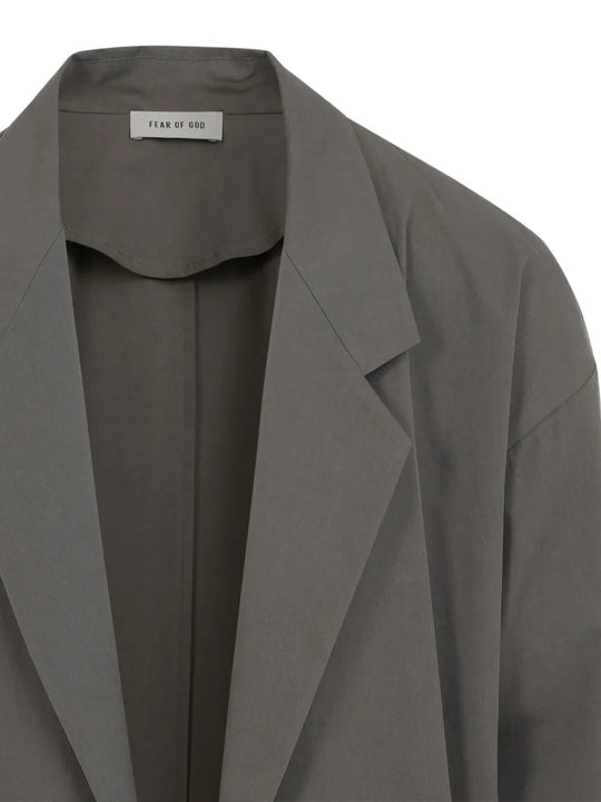 Close up of grey blazer, showing texture of the cotton fabric