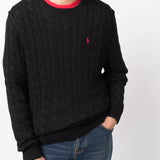 Black sweater worn by a person, showing the sweater's fit