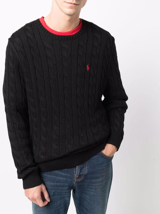 Black sweater worn by a person, showing the sweater's fit