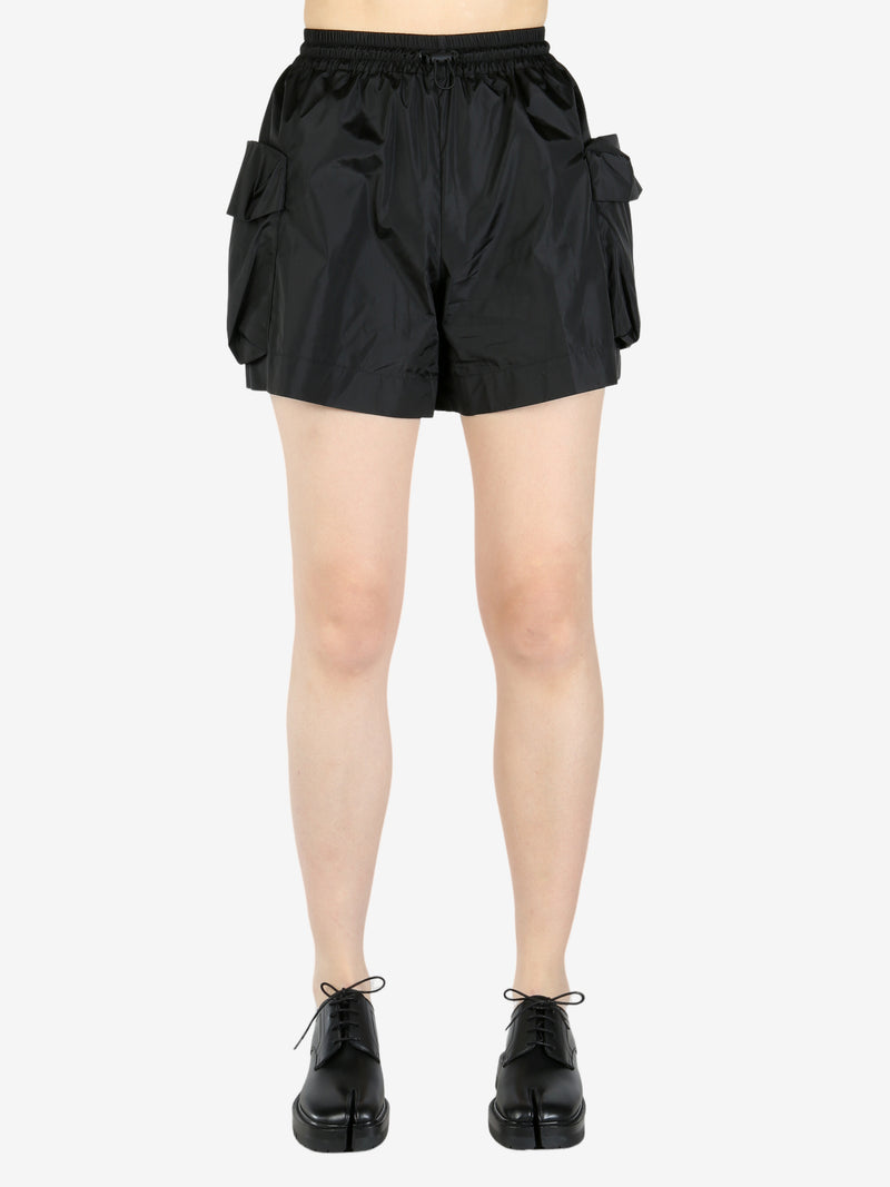 Black shorts worn by a person, showing the shorts fit
