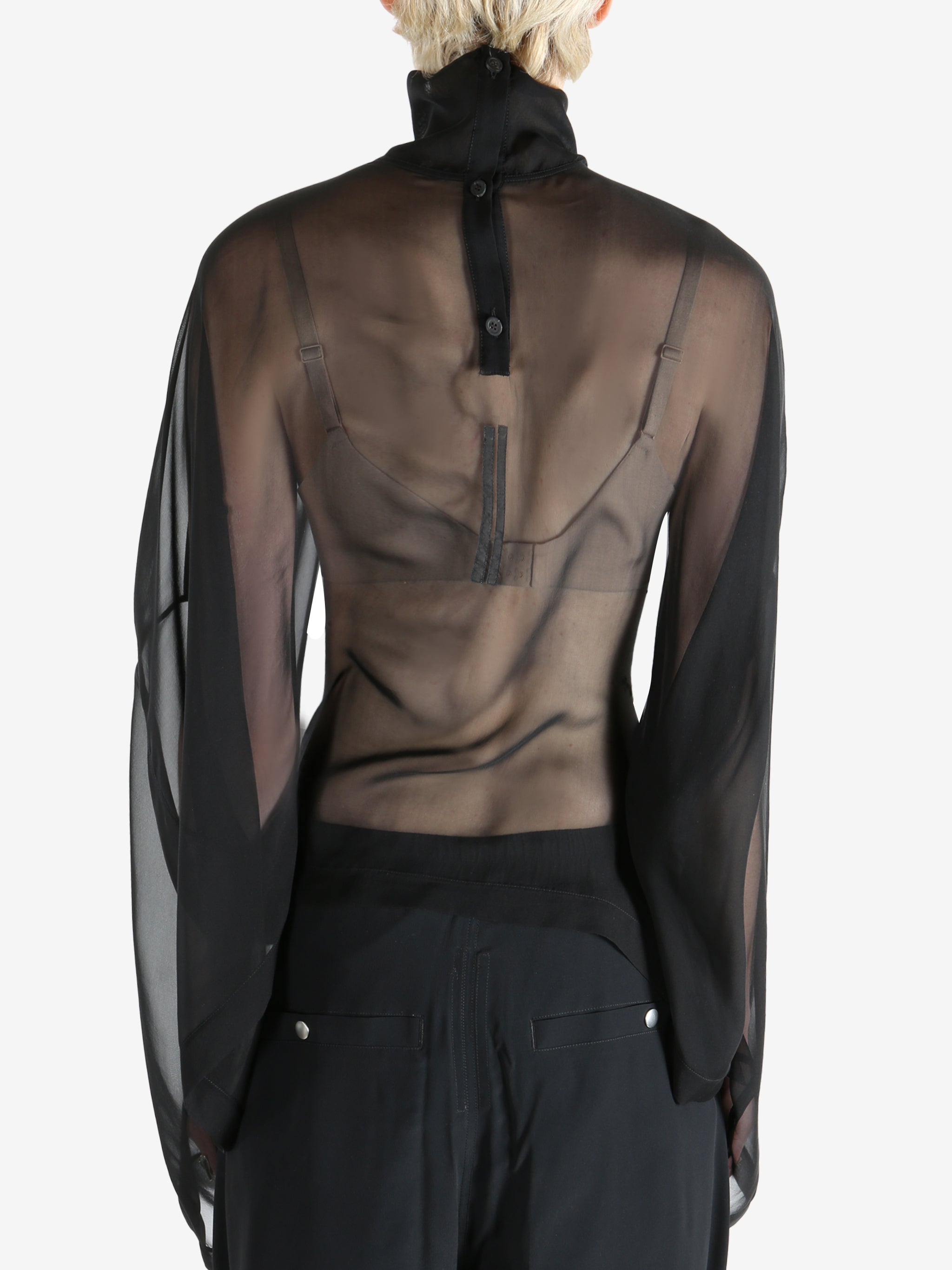 Black top worn by a person, showing the top's fit