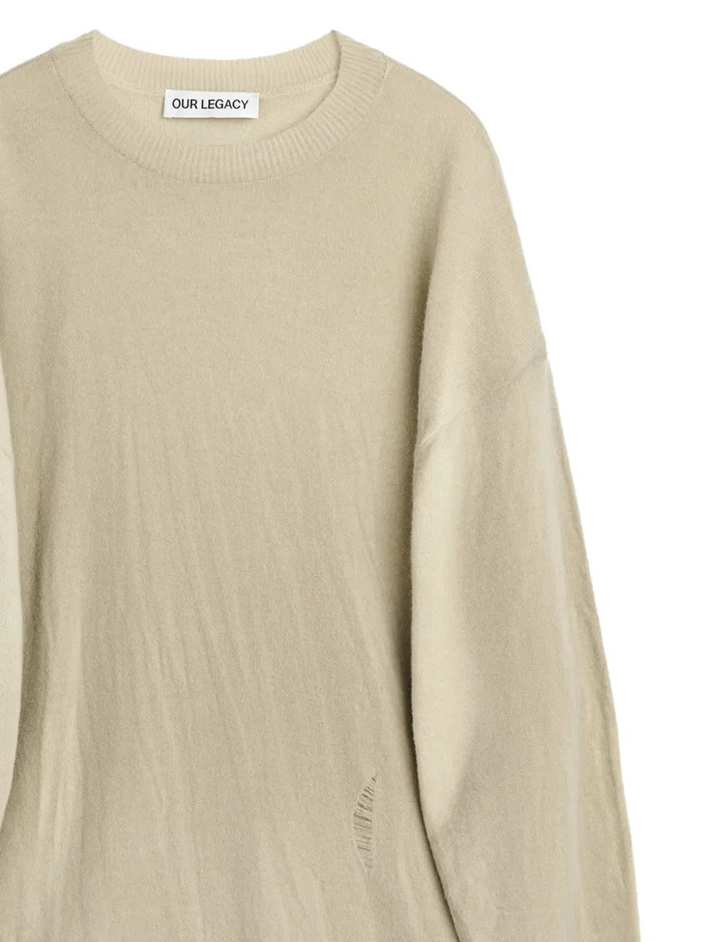 Close up of tan knitwear, showing texture of the merino wool fabric