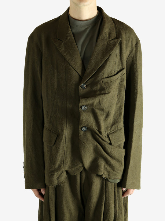 Green blazer worn by a person, showing the blazer's fit