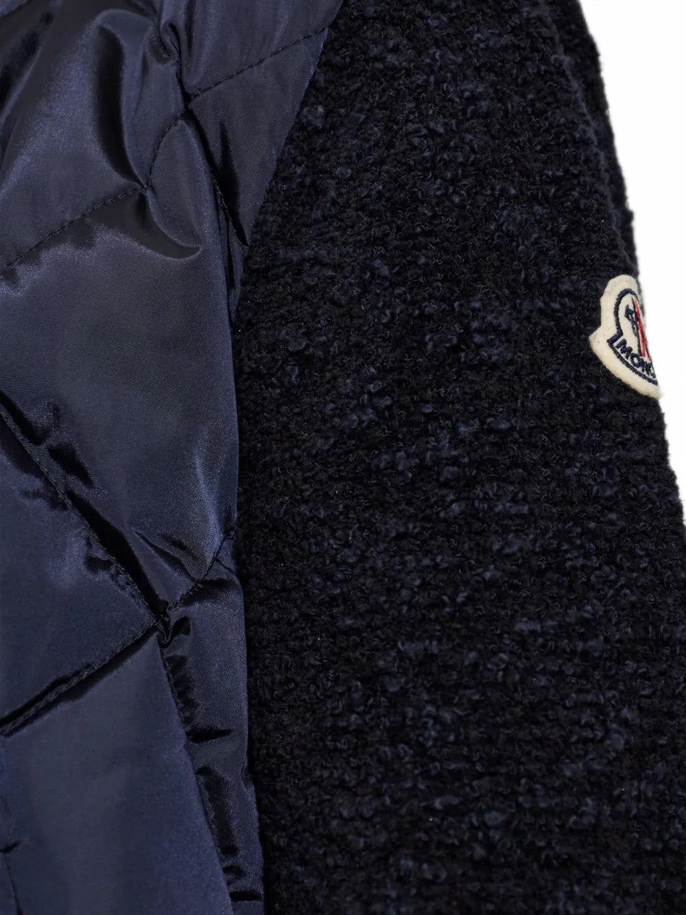 Close up of Navy jacket, showing texture of the 100% polyamide fabric