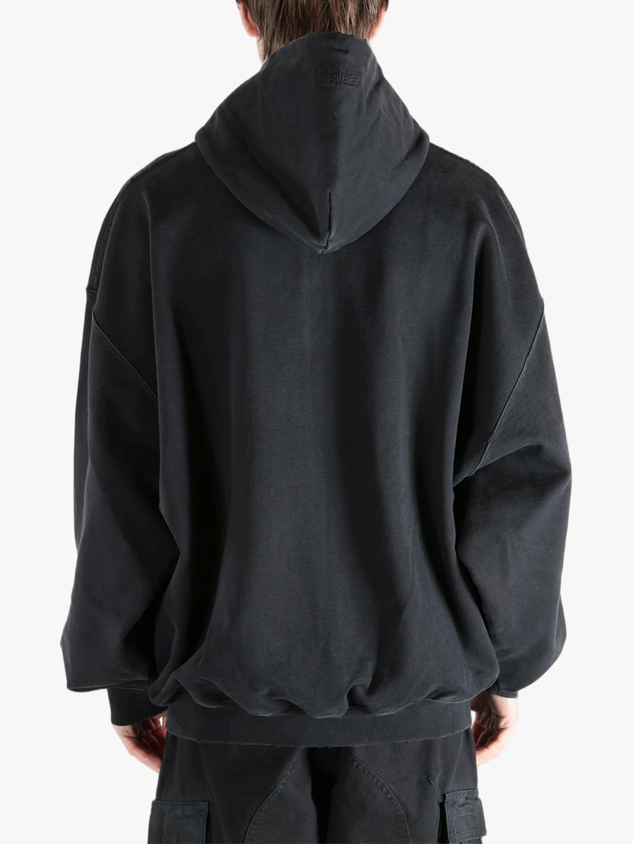 Black hoodie worn by a person, showing the hoodie fit