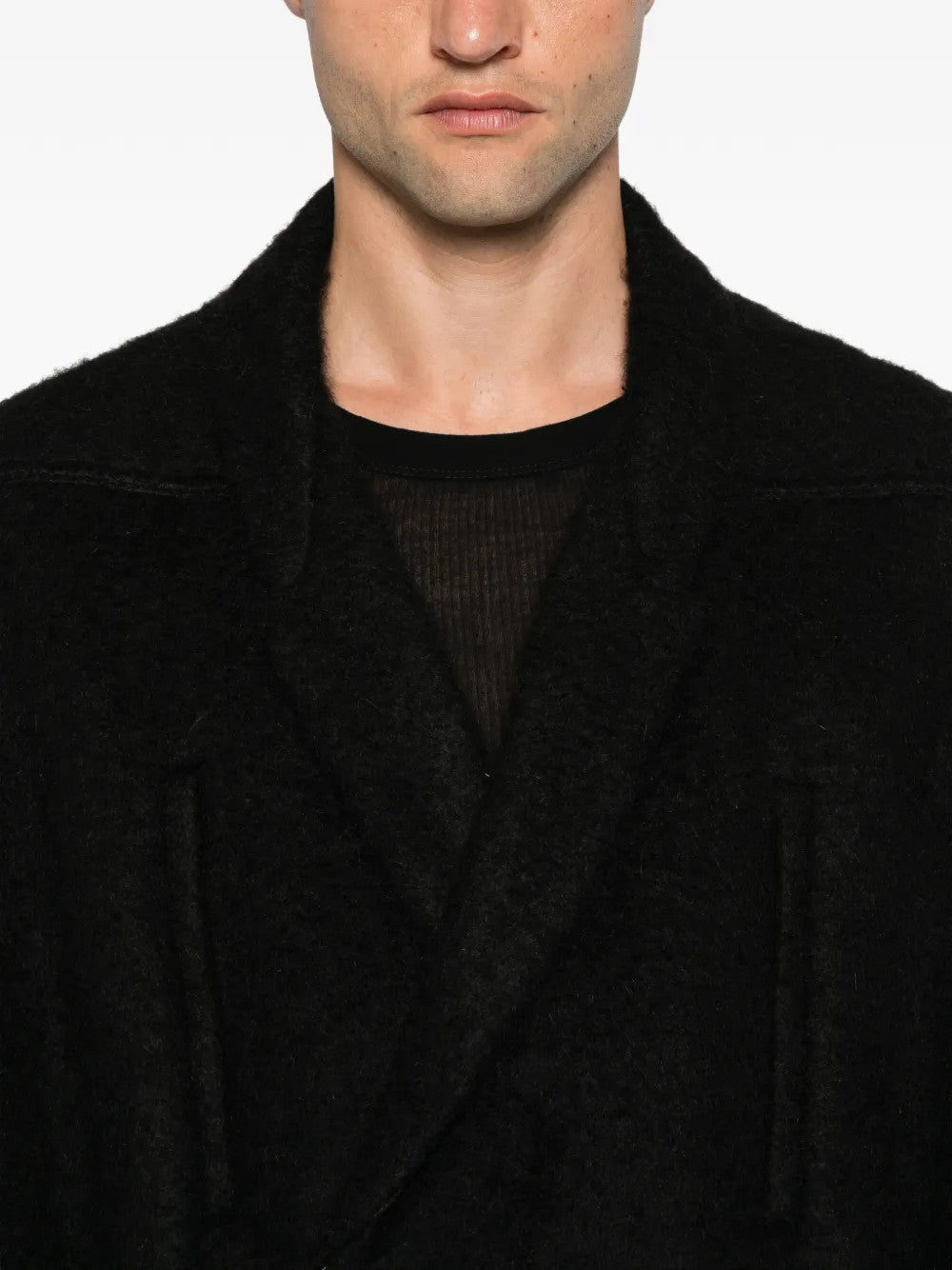 Black jacket worn by a person, showing the jacket fit