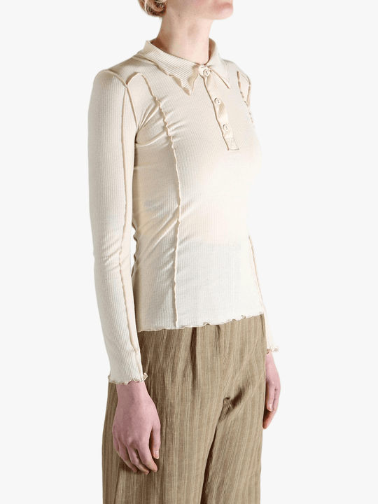 White top worn by a person,showing the top fit