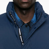 Close up of navy jackets, showing texture of the nylon and polyester and down and feather fabric