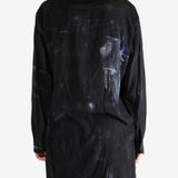 Black shirt worn by a person, showing the shirt's fit