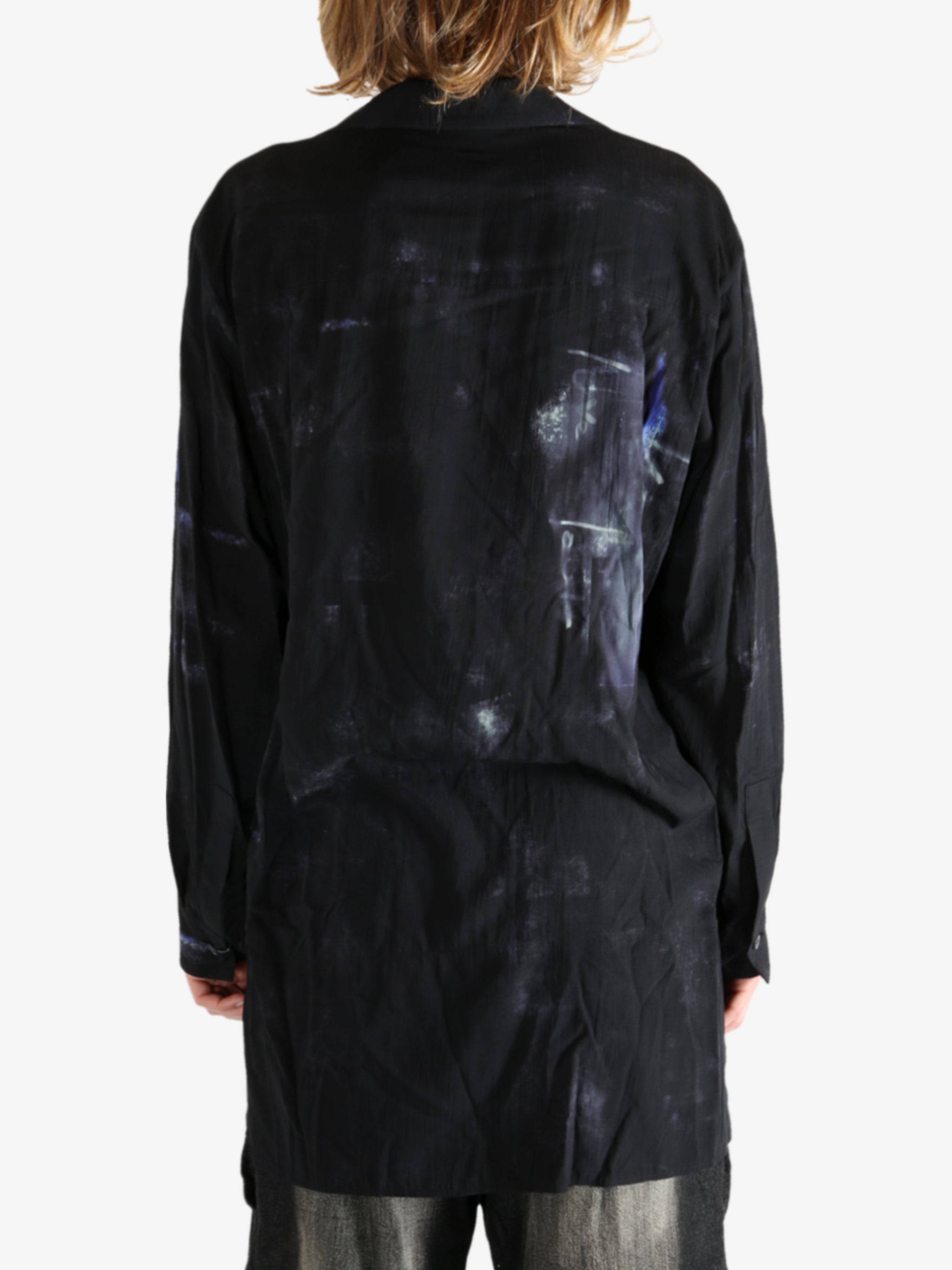 Black shirt worn by a person, showing the shirt's fit