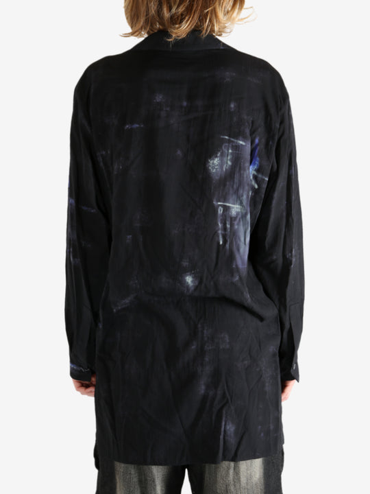 Black shirt worn by a person, showing the shirt's fit