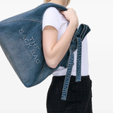 blue bags worn by a person, showing the bags fit
