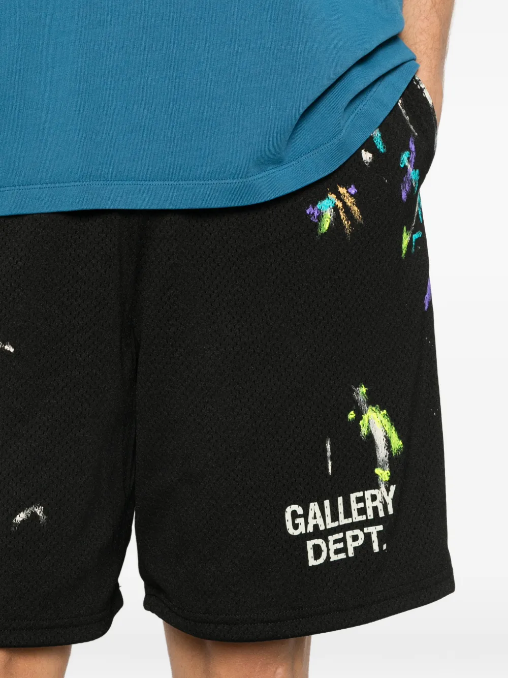 Close up of black shorts, showing texture of the polyester fabric