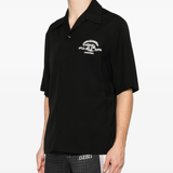 black shirt worn by a person, showing the shirt fit