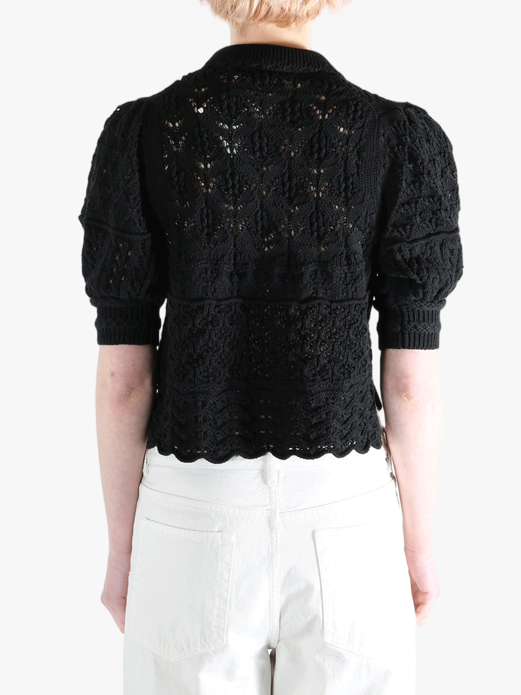 Black sweater worn by a person, showing the sweater fit