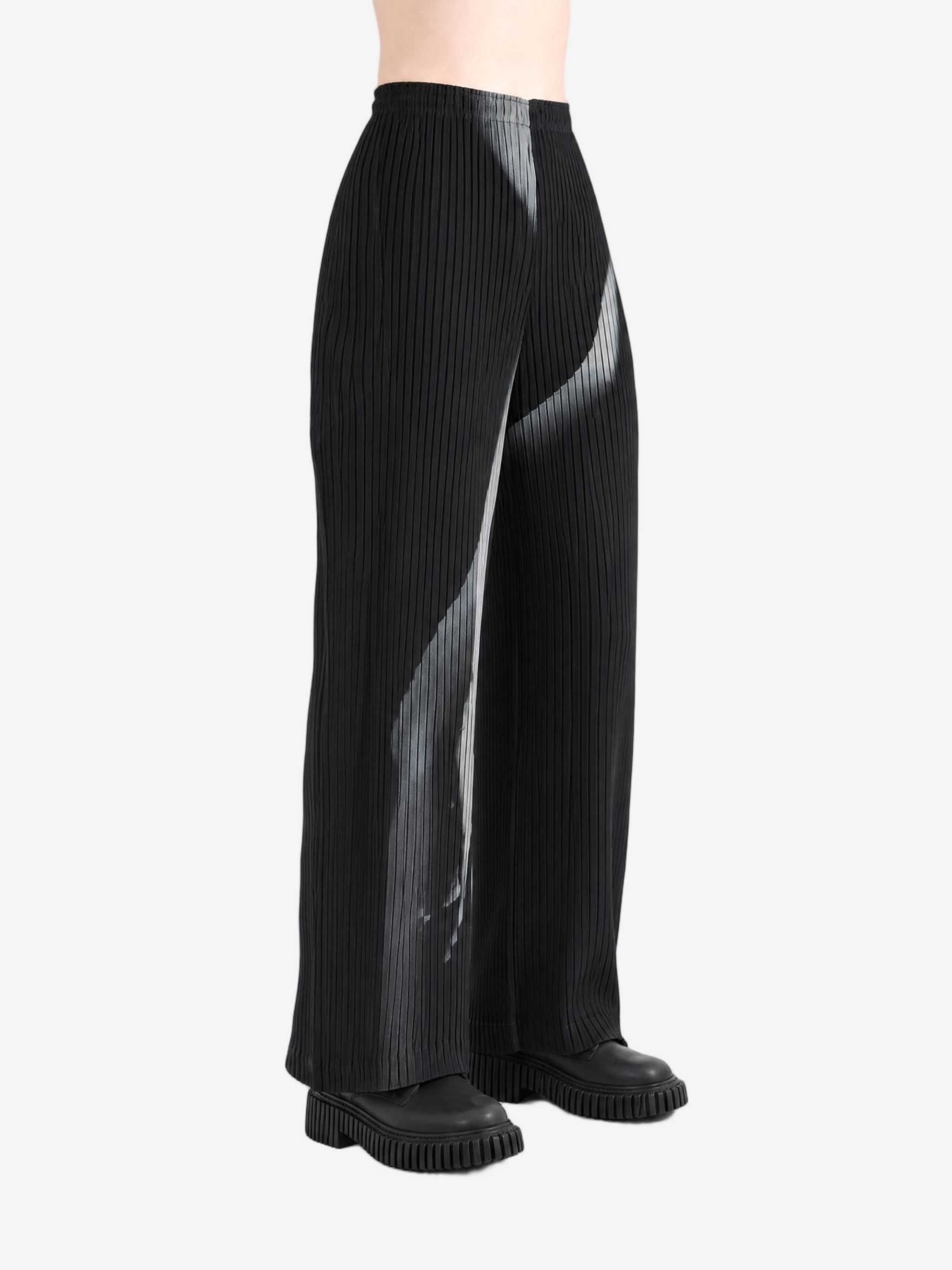 Black pants worn by a person, showing the pants fit