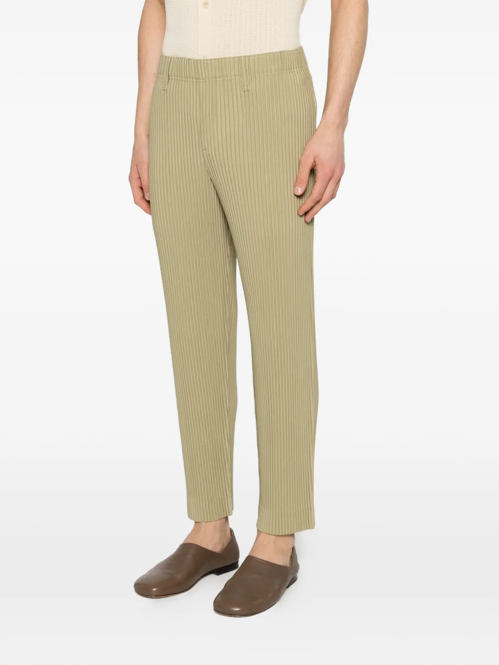 green pants worn by a person, showing the pants fit