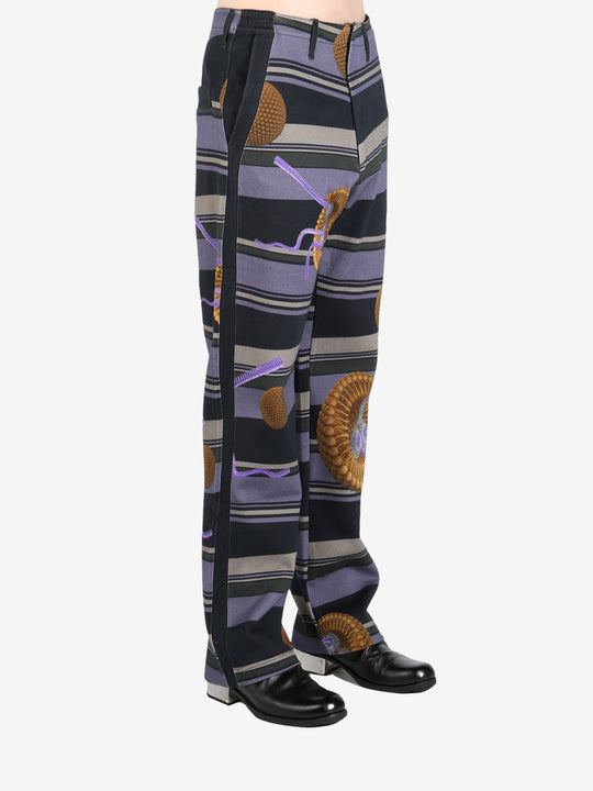 Black pants worn by a person, showing the pants' fit